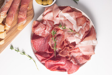 Charcuterie board. Antipasti appetizers of meat platter with salami, prosciutto crudo or jamon and...