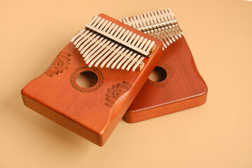 wooden kalimba on beige background, traditional african musical instrument, meditation instrument, copy space