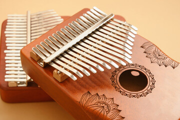 wooden kalimba on beige background, traditional african musical instrument, meditation instrument, copy space close up