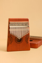wooden kalimba on beige background, traditional african musical instrument, meditation instrument, copy space