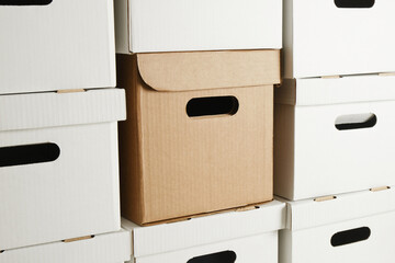 one brown box and a pile of white cardboard boxes with slots for holding, storage boxes, wall of boxes, mock up