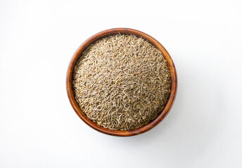 Indian food spice called cumin or jeera in wooden bowl isolated on white background