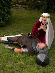 Knight in armor dead and crying widow