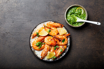  Fried shrimps with lemon and green in a plate, top view, copy space for text