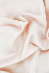 Soft fabric draped elegantly on a surface creating gentle folds and waves