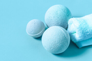 Relaxing bath products arranged on a calming blue surface for spa experience at home