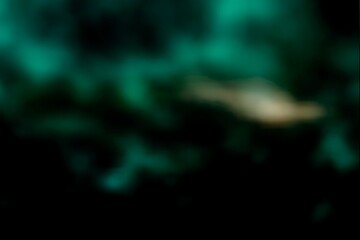 Abstract teal and gold nebula with dark background