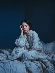 Woman sleeping in bed, covered in a floral patterned quilt, resting her head on her hand with eyes closed.