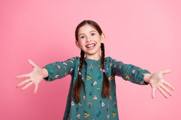 Happy young girl with braided hair extending arms in a welcoming gesture, smiling brightly against...