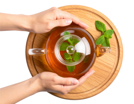 Top View of Herbal Tea in Glass Teapot with Hand and Window Reflection