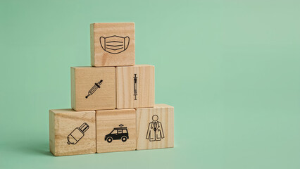 Obraz premium Healthcare and medicine represented by wooden blocks featuring medical equipment on a green backdrop.