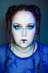 Futuristic woman with bold makeup, glowing blue eyes, circuit patterns on her face, braided hair...