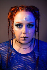 Futuristic woman with bold makeup, glowing blue eyes, circuit patterns on her face, braided hair...
