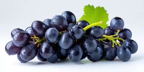 The vibrant cluster of fresh purple grapes with water droplets