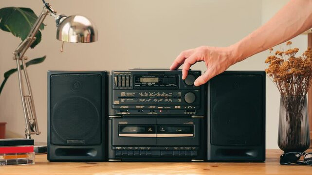 Retro radio tape recorder, audio cassette close-up. Listening to music, old radio boom box player, macro of vintage music listening. 