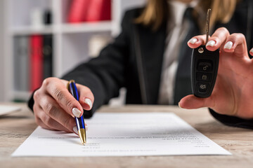 Car dealers gives the car keys to the new owner at showrooms