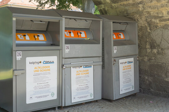 Austria, Hainburg an der donau, Europe - July 05, 2025: a row of "kolping opula altkleider und schuhe" donation bins for clothes and shoes, concept of charity, recycling, sustainable living