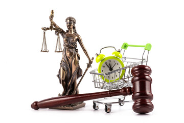 Judge's gavel, Themis figure and alarm clock in miniature shopping cart on white background