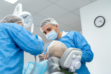  male dentist and nurse working with senior woman the clinic dentistry, healthcare people insurance