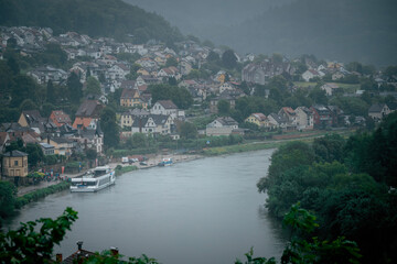 Fototapeta premium Dramatic Clouds Over the Neckar River in Neckarsteinach, Germany
