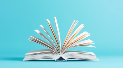 Open book pages fanning out on blue background knowledge concept