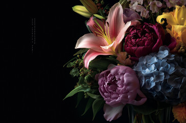 A close-up of an arrangement of flowers, including lilies and hydrangeas