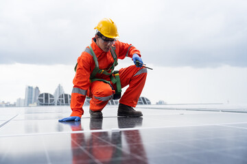 Solar panel rooftop, Rooftop solar power. Engineer or technician inspecting installation quality of solar power systems on rooftop of building. Male engineer checks solar panel on rooftop