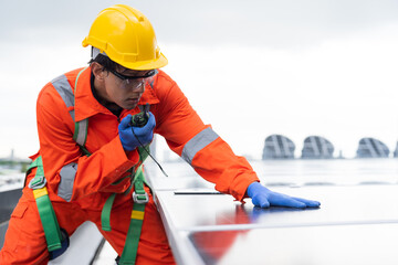 Solar panel rooftop, Rooftop solar power. Engineer or technician inspecting installation quality of solar power systems on rooftop of building. Male engineer checks solar panel on rooftop