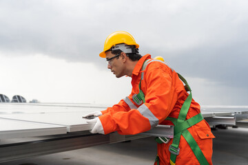 Solar panel rooftop, Rooftop solar power. Engineer or technician inspecting installation quality of solar power systems on rooftop of building. Male engineer checks solar panel on rooftop