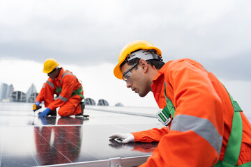 Solar panel manufacturers, Rooftop solar power, Solar rooftop. Team of engineers or technicians with safety uniform maintaining and repairing solar power systems rooftop of building