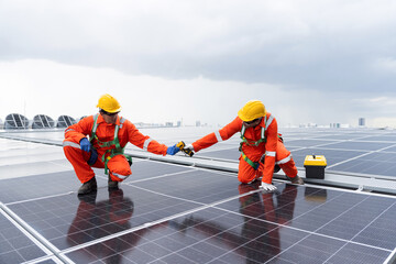 Solar panel manufacturers, Rooftop solar power, Solar rooftop. Team of engineers or technicians with safety uniform maintaining and repairing solar power systems rooftop of building