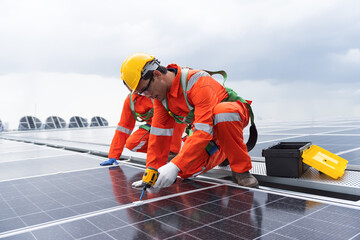 Solar panel manufacturers, Rooftop solar power, Solar rooftop. Team of engineers or technicians with safety uniform maintaining and repairing solar power systems rooftop of building