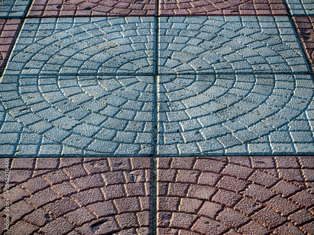 Poster abstract stone pavement background. close-up of paving slabs with a rounded pattern. copy space.
