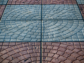 Abstract stone pavement background. Close-up of paving slabs with a rounded pattern. Copy space.