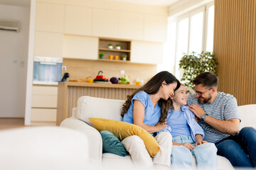 Smiles and laughter fill the cozy living room as a family enjoys precious moments together in their bright home
