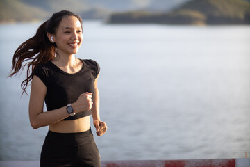 Portrait of Asian female runner jogging on street because jogging is a good exercise for good...