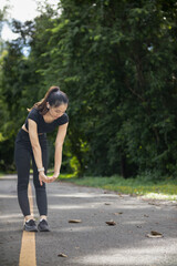 Portrait of beautiful female runner wearing workout clothes and warm up her body get ready for jogging in morning get good health. female runner warm up her body alone get ready for jogging in park.