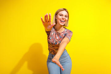 Cheerful young woman in casual fashion with vibrant background expressing joy and enthusiasm