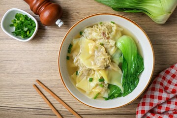 Wonton with bok choy Soup in a ceramic bowl	