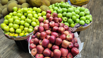 Fresh fruits and vegetables placed on cases and stands in the grocery section