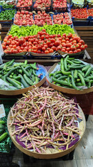 Fresh fruits and vegetables placed on cases and stands in the grocery section