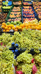 Fresh fruits and vegetables placed on cases and stands in the grocery section