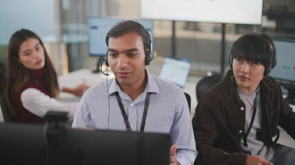Indian call center professional working with global clients in a modern tech office. Delivering CRM support, customer service, and telemarketing advice in a culturally diverse workplace. - Powered by Adobe