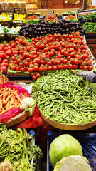 Fresh fruits and vegetables placed on cases and stands in the grocery section