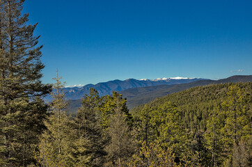 Traveling through the Sangre de Cristo Mountains between Las Vegas and Taos, New Mexico, flowing rivers, snow capped mountains, pine trees, beautiful scenery.