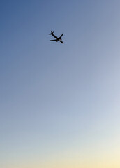 Minimalist Airplane Flying in a Clear Blue Sky