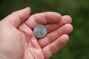 Commemorative quarter coin in hand