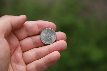 Commemorative quarter coin in hand