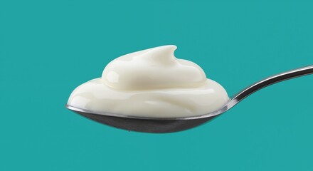 Yogurt spoon swirl turquoise background. Creamy dairy product white dessert. Healthy breakfast snack concept