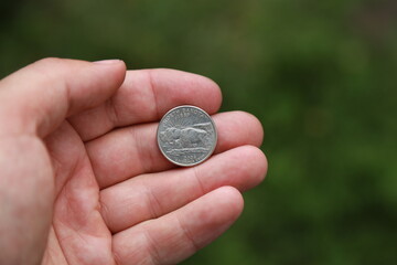 Commemorative quarter coin in hand